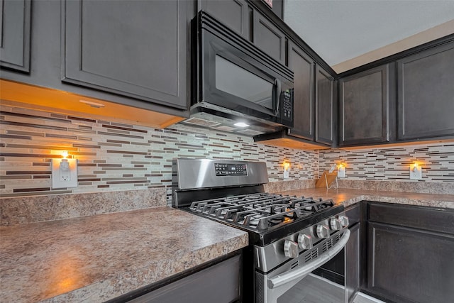 kitchen featuring gas stove, black microwave, and backsplash