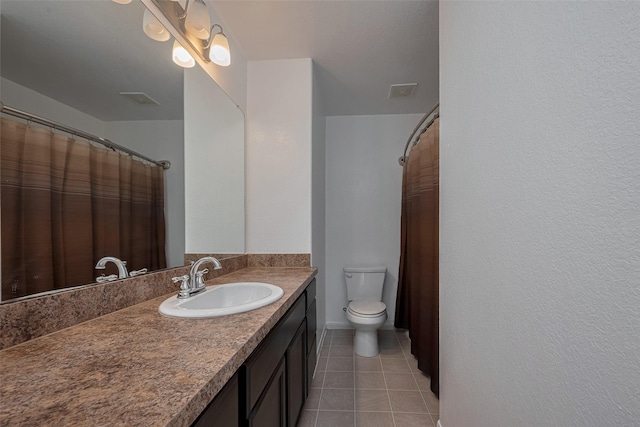 full bathroom with tile patterned floors, vanity, and toilet