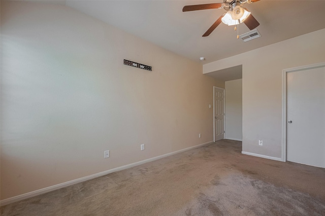 spare room with lofted ceiling, ceiling fan, carpet flooring, and baseboards