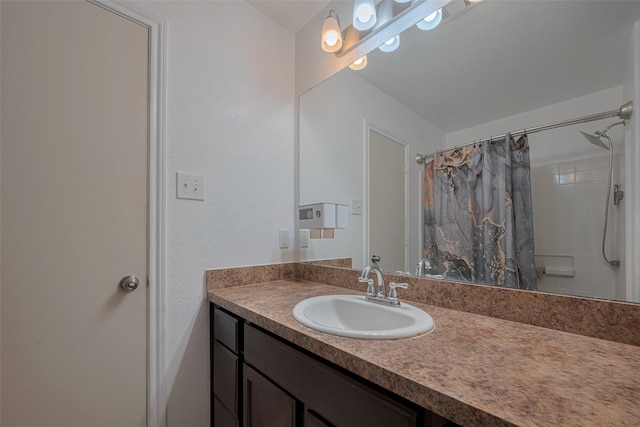 bathroom with vanity and curtained shower