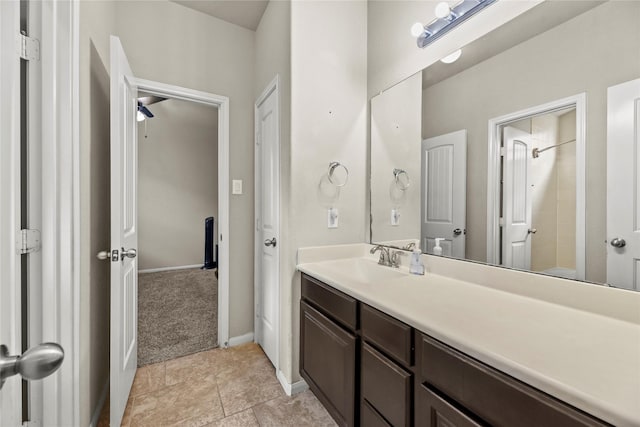 full bathroom featuring vanity, baseboards, and a shower