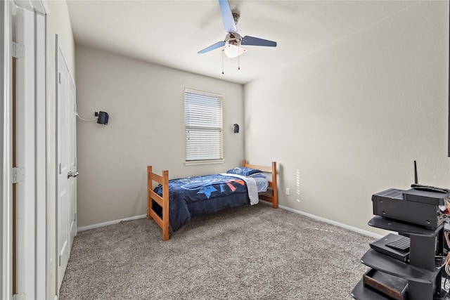 carpeted bedroom featuring baseboards and ceiling fan