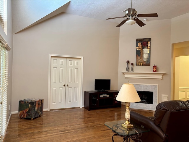 3923 Fordham Park Ct, Pasadena, TX 77058 - living area featuring wood finished floors, a ceiling fan, a tile fireplace, and vaulted ceiling