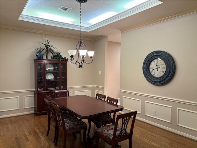 3923 Fordham Park Ct, Pasadena, TX 77058 - dining room with a decorative wall, a chandelier, dark wood-type flooring, ornamental molding, and a wainscoted wall