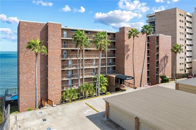 view of apartment building / complex with a water view