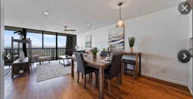 dining area with floor to ceiling windows, wood finished floors, ceiling fan, and baseboards