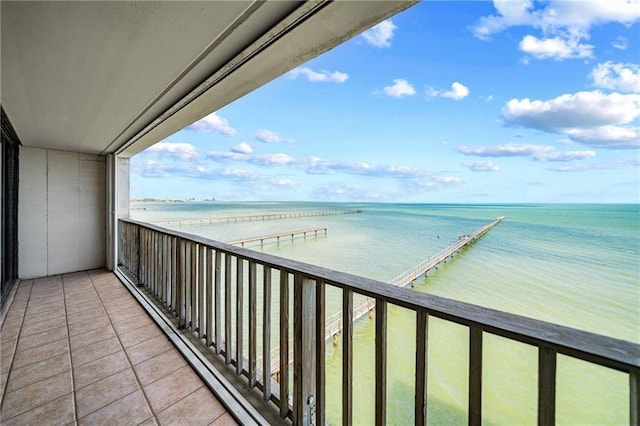 balcony with a water view and a baseboard radiator