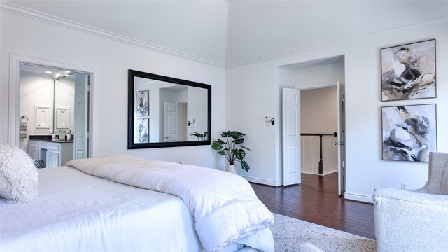 bedroom with dark wood-style flooring, baseboards, ornamental molding, and ensuite bath