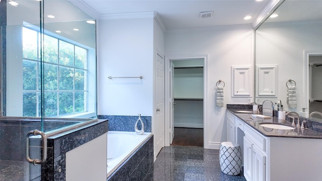 bathroom featuring ornamental molding, a bath, double vanity, baseboards, and recessed lighting