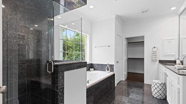 full bath with granite floors, crown molding, a stall shower, a garden tub, and vanity