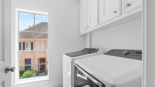 laundry area featuring washing machine and dryer and cabinet space