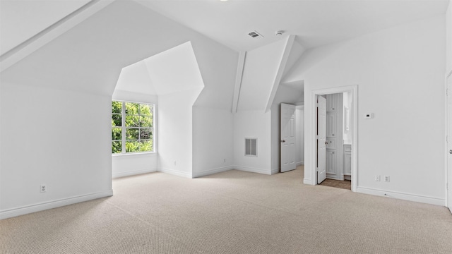additional living space featuring carpet flooring, vaulted ceiling, and baseboards