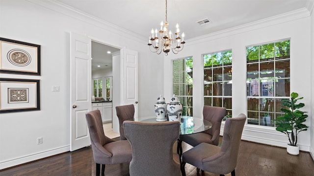 dining room featuring a chandelier, plenty of natural light, crown molding, dark wood-type flooring, and baseboards