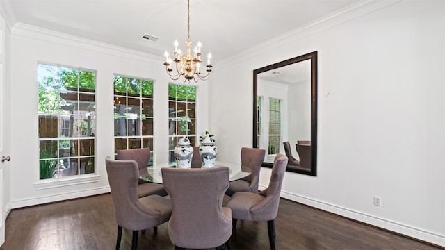 dining space featuring a chandelier, ornamental molding, wood finished floors, and baseboards