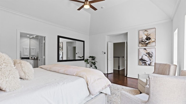 bedroom featuring dark wood-type flooring, ornamental molding, vaulted ceiling, connected bathroom, and baseboards