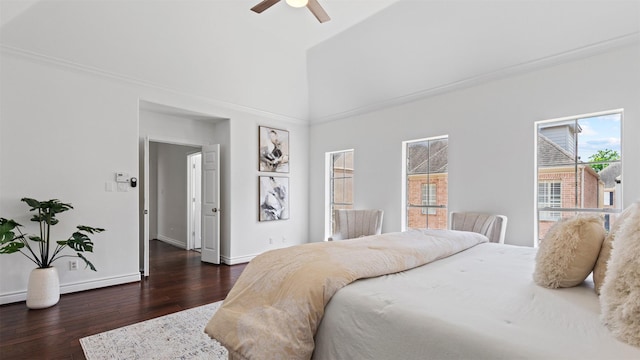 bedroom featuring dark wood-type flooring, baseboards, high vaulted ceiling, and ceiling fan