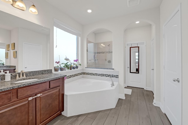 8207 Oxbow Manor Ln, Cypress, TX 77433 - full bathroom with a bath, vanity, tiled shower, baseboards, and recessed lighting