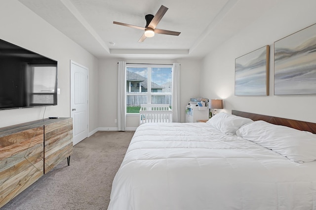 8207 Oxbow Manor Ln, Cypress, TX 77433 - bedroom featuring carpet floors, a raised ceiling, a ceiling fan, and baseboards