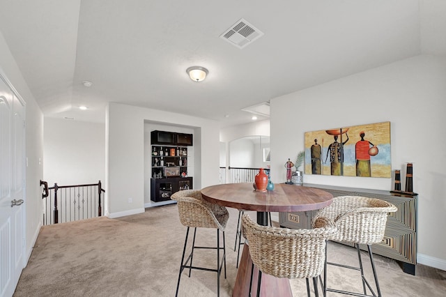 8207 Oxbow Manor Ln, Cypress, TX 77433 - dining space with baseboards, light carpet, recessed lighting, arched walkways, and vaulted ceiling