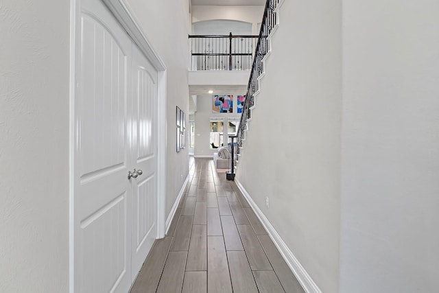 8207 Oxbow Manor Ln, Cypress, TX 77433 - hall featuring baseboards, a high ceiling, and wood tiled floors