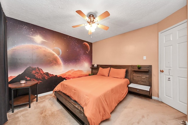 carpeted bedroom with a textured ceiling, a ceiling fan, and baseboards