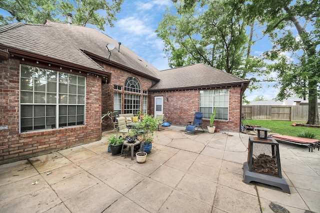 view of patio with fence and an outdoor fire pit