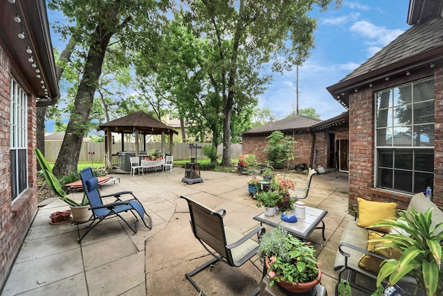 view of patio / terrace featuring a gazebo, outdoor dining space, and a fenced backyard