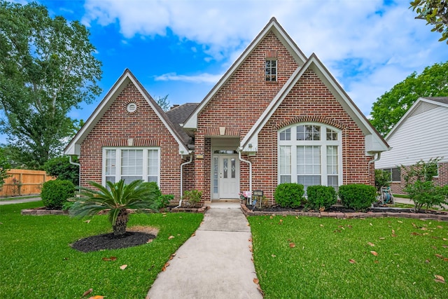 english style home with brick siding