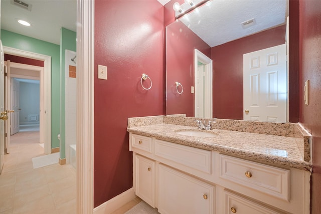 bathroom with vanity, shower / tub combination, and baseboards