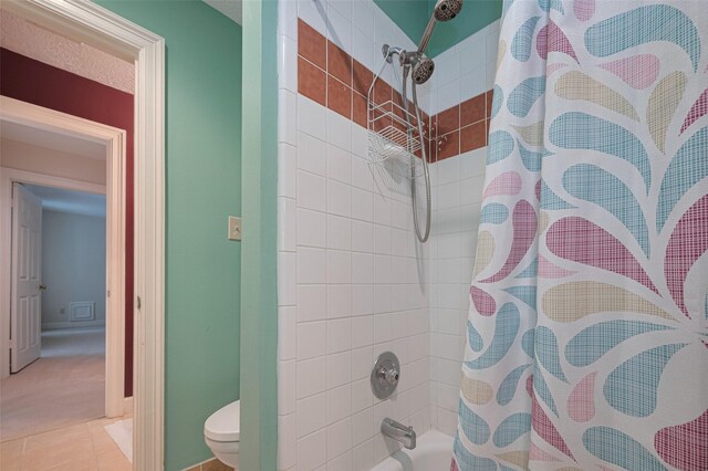 bathroom featuring toilet and shower / tub combo with curtain