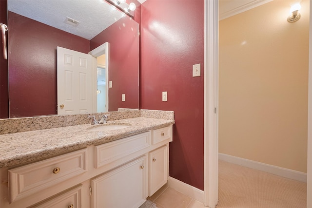 bathroom featuring baseboards, vanity, and tile patterned flooring