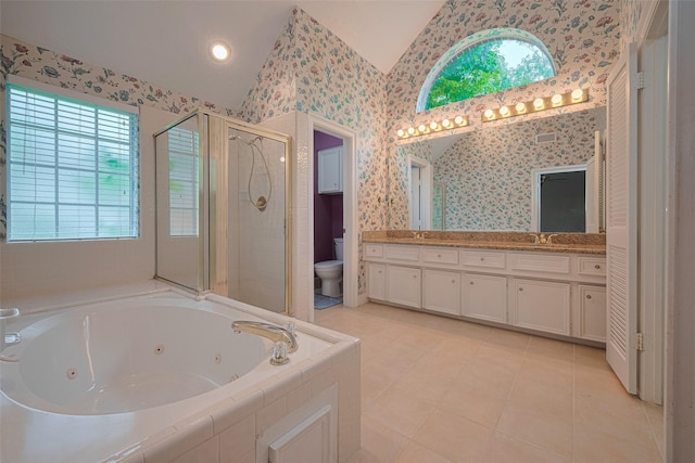 full bath featuring lofted ceiling, a stall shower, toilet, a jetted tub, and double vanity