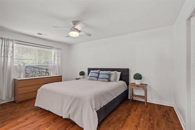 bedroom with wood finished floors, ceiling fan, and baseboards