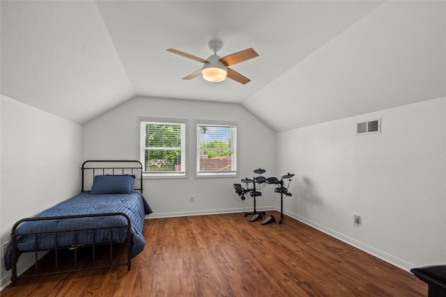 bedroom featuring lofted ceiling, wood finished floors, baseboards, and a ceiling fan