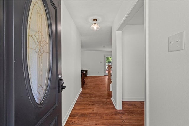 entrance foyer with dark wood-style floors and baseboards