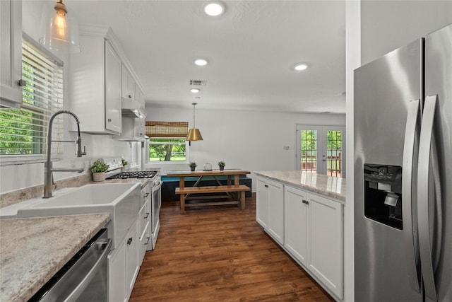 kitchen featuring stainless steel appliances, white cabinetry, dark wood-style floors, recessed lighting, and decorative light fixtures