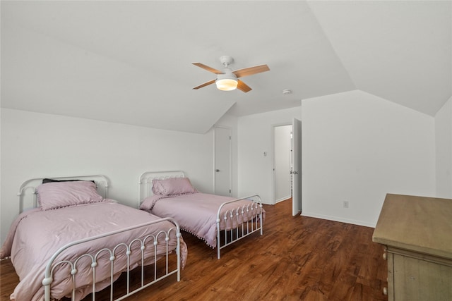 bedroom featuring vaulted ceiling, wood finished floors, ceiling fan, and baseboards