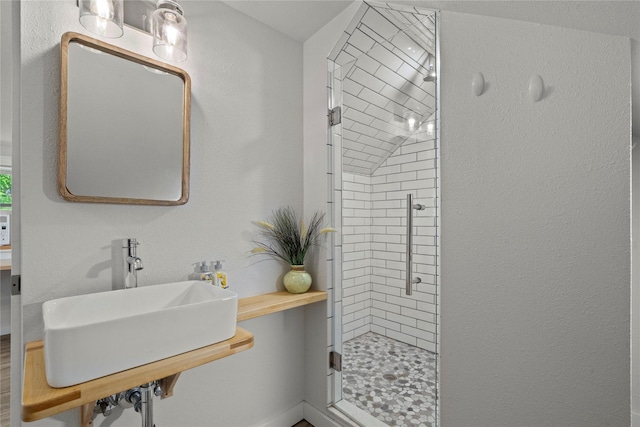 full bath featuring a shower stall and a sink