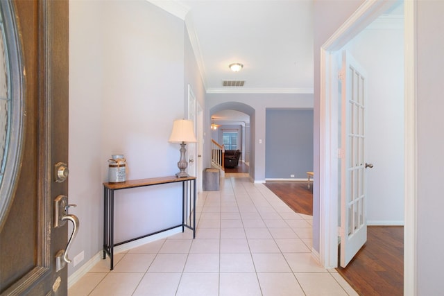 2835 Chalet Knolls Ln, Katy, TX 77494 - foyer entrance featuring ornamental molding, arched walkways, stairs, baseboards, and light tile patterned flooring