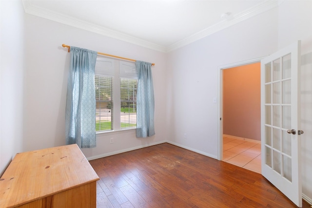 2835 Chalet Knolls Ln, Katy, TX 77494 - unfurnished room with wood-type flooring, crown molding, french doors, and baseboards