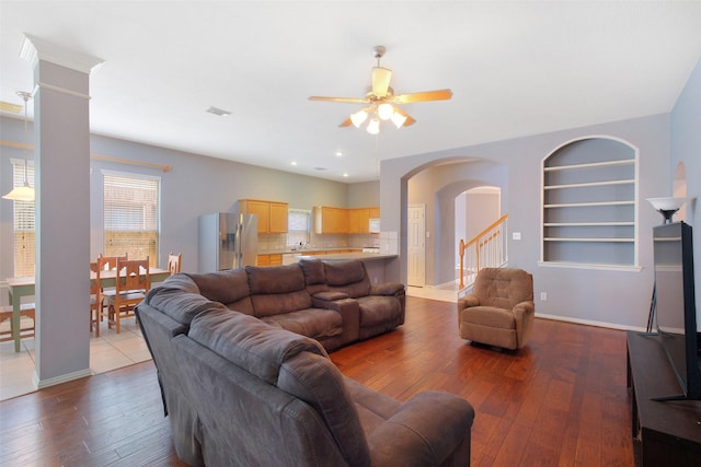 2835 Chalet Knolls Ln, Katy, TX 77494 - living area with ceiling fan, hardwood / wood-style floors, arched walkways, built in shelves, and baseboards