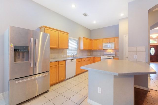 2835 Chalet Knolls Ln, Katy, TX 77494 - kitchen featuring white appliances, light brown cabinets, light countertops, tasteful backsplash, and recessed lighting