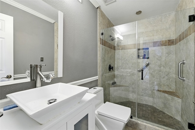full bathroom with toilet, a shower stall, ornamental molding, and vanity