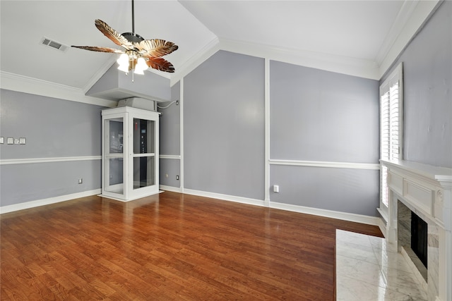 unfurnished living room with a ceiling fan, a high end fireplace, lofted ceiling, wood finished floors, and baseboards
