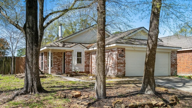 31311 N Head Dr, Spring, TX 77386 - view of front of property featuring brick siding, a garage, fence, and concrete driveway