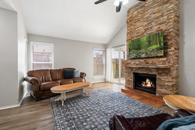 31311 N Head Dr, Spring, TX 77386 - living area with a fireplace, wood finished floors, ceiling fan, baseboards, and lofted ceiling