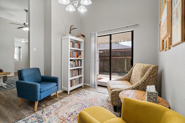 31311 N Head Dr, Spring, TX 77386 - living area with wood finished floors, a towering ceiling, a chandelier, a ceiling fan, and baseboards