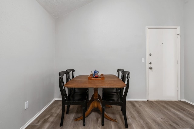 31311 N Head Dr, Spring, TX 77386 - dining space with wood finished floors, baseboards, a textured ceiling, and lofted ceiling