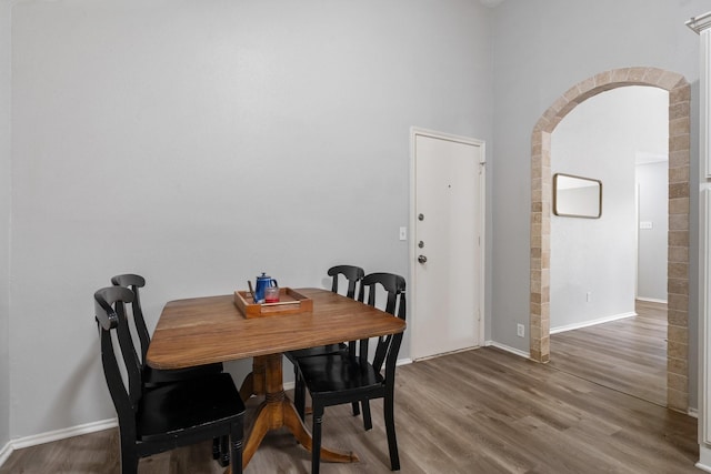 31311 N Head Dr, Spring, TX 77386 - dining space featuring arched walkways, wood finished floors, and baseboards