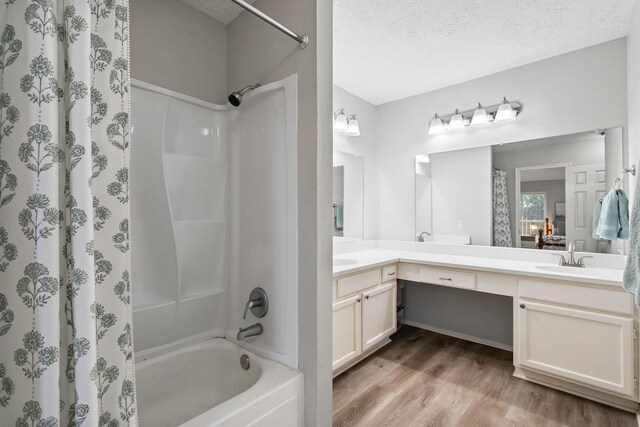 31311 N Head Dr, Spring, TX 77386 - bathroom with shower / bath combo with shower curtain, double vanity, wood finished floors, and a textured ceiling